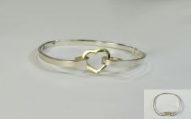 Silver Bangle with heart shaped gilt fastener. Stamped 925.