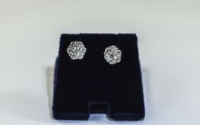 Pair of Ladies Diamond Cluster Stud Earrings each set with 7 round modern brilliant cut diamonds.