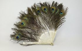 Early 20thC Bone Framed Hand Fan with peacock feathers. A/F condition.