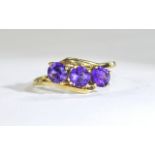 18ct Gold Set 3 Stone Amethyst Ring. The Amethysts of Good Colour and Clarity. Marked 750.