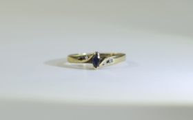 9 Carat Gold Dress Ring central marque cut sapphire between 2 round cut diamonds.