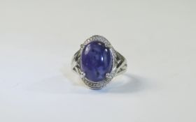 Purple Opal Ring, an oval cut cabochon of one of the most unusual colours of opal, a mottled deep