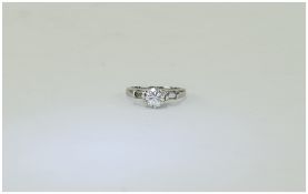 18 Carat White Gold Single Stone Diamond Ring set with a round brilliant cut diamond between