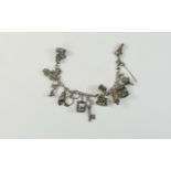 A Silver Charm Bracelet, Loaded with 13