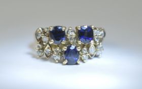 14ct Gold Sapphire and Diamond Cluster Ring set with 3 Sapphires between round cut diamonds.