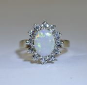 Ladies 9ct Gold Set Opal and Diamond Cluster Ring. The Central Opal Surrounded by 16 Small Diamonds.