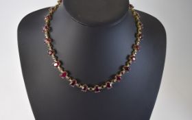 14ct Gold Ruby And Diamond Line Necklace 25 Oval Cut Rubies Set Between A Smaller Ruby And Two