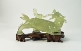 Chinese Jade Figure of a Mythical Dragon, Raised on a Wooden Shaped Stand.
