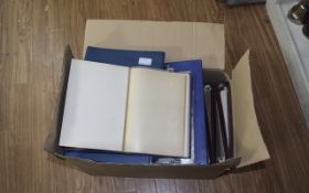 Large box of assorted empty stamp albums, cover albums and other loose philatelic items.