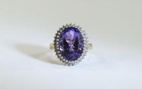 9ct Gold Diamond Dress Ring Set with a large central Amethyst Coloured stone surrounded by small