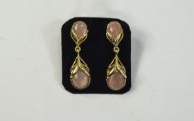 Peach Sunstone Pair of Drop Earrings, a pear cut cabochon in an openwork setting of 14ct gold