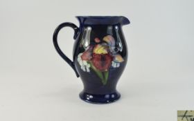 Moorcroft 'Orchid' Pattern Jug, a single tubelined orchid to one side and a further single orchid