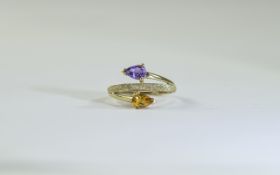 9 Carat Gold Dress Ring set with 2 round pear shaped gemstones and textured gold design., Fully