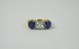 18ct Gold Diamond and Sapphire 3 Stone Ring Central round brilliant cut diamond set between 2 round