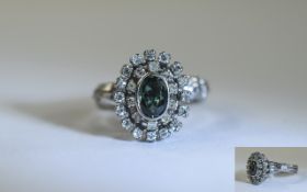 18ct White Gold Diamond Cluster Ring. Set with a central fancy green Sapphire, surrounded by 26