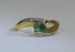 18ct Gold Set Emerald and Diamond Ring. The Central Set Emerald of Good Colour and Clarity. 4.