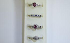 4 x Silver Rings Collection of rings in various designs featuring red and blue stone setting