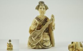 Japanese Very Finely Carved and Signed 19th Century Ivory Netsuke of a Geisha Girl Playing a