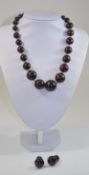 Dark Red Amber Necklace and Earrings, the necklace comprising 27 graduated, round,