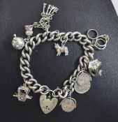 Heavy Silver Charm Bracelet Featuring approx 8 charms including thistle, cat ,