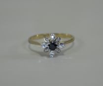 Diamond Sapphire Cluster Ring Flowerhead formation with central sapphire and unusual diamond petals