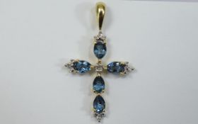 Gold Diamond/Topaz Cross Small cross with blue faceted Topaz and diamond setting