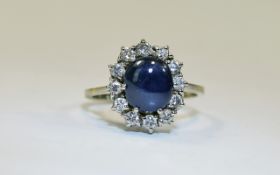 18ct Gold Diamond And Sapphire Cluster Ring Central Cabochon Cut Sapphire Surrounded By 12 Round