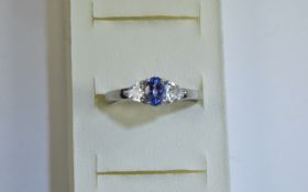 Tanzanite and White Topaz Ring, a .5ct oval cut tanzanite flanked by two trillion cut .