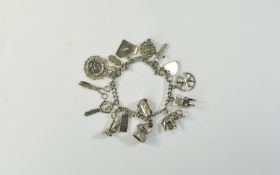 A Vintage Silver Charm Bracelet loaded with 20 vintage charms All fully hallmarked. 50 grams.