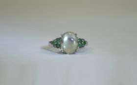 Green Moonstone and Emerald Ring, an oval cut, 3ct cabochon of green moonstone, flanked by .
