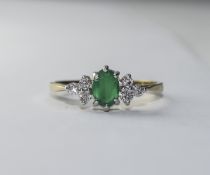 Diamond/Emerald Cluster Ring Pretty ring with central raised setting featuring small, oval,