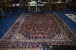 A Large Persian Carpet In The Meshad Style, with a central floral motif with corresponding blue