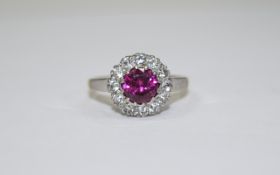 9ct Gold Ruby and Diamond Cluster Ring central ruby surrounded by round cut diamonds.