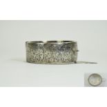 A 1950's - Nice Quality Silver Wide Banded and Floral Engraved Hinged Bangle with Safety Chain.