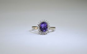 9ct Gold Amythist and Diamond Cluster Ring central oval amethyst surround by round cut diamonds.