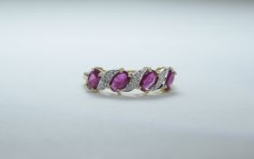 9 ct Gold Diamond Dress Ring Set with 4 oval rubies between diamond spacers,