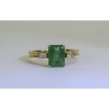 18ct Gold Set Single Stone Emerald Ring with Diamond Shoulders.