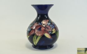 W. Moorcroft Signed Globular Shaped Vase ' Orchids ' Design on Blue Ground. c. Early 1940's.