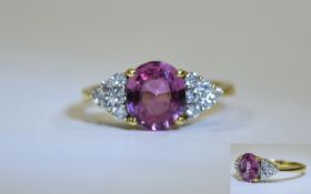 Ladies 18ct Pink Sapphire & Diamond Ring. Central oval pink sapphire set between 12 brilliant cut