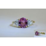 Ladies 18ct Pink Sapphire & Diamond Ring. Central oval pink sapphire set between 12 brilliant cut