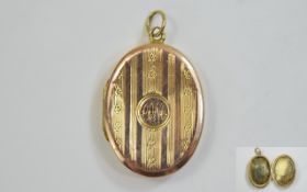 9ct Gold Oval Locket engine turned front. Early 20thC, hallmark rubbed, 28 x 18 mm.