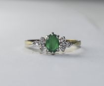 Diamond/Emerald Cluster Ring Pretty ring with central raised setting featuring small, oval,