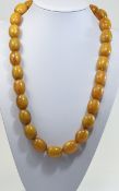 Early 20thC Egg Yolk Amber Necklace Consisting Of 28 Natural Amber Beads Of Uniform Size Approx