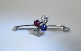 Ladies Sapphire, Diamond & Ruby Bar Brooch. Applied round cut diamond, sapphire and ruby set in a '