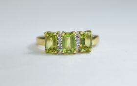 9ct Gold Diamond and Peridot Ring three emerald cut Peridot between round cut diamond spacers.