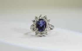 18ct Gold Tanzanite and Diamond Cluster Ring central oval tanzanite surrounded by 12 round modern