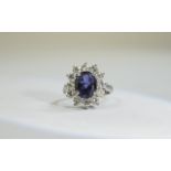 18ct Gold Tanzanite and Diamond Cluster Ring central oval tanzanite surrounded by 12 round modern