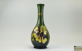 W. Moorcroft Tube lined Bottle Shaped Vase ' Hibiscus ' Design on Emerald Green Ground. Impressed