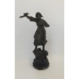 Metal Figure On Wooden Base female figure in peasant dress with arm thrust in the air,