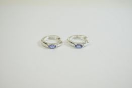 Tanzanite Solitaire Hoop Earrings, each having an oval cut tanzanite of .